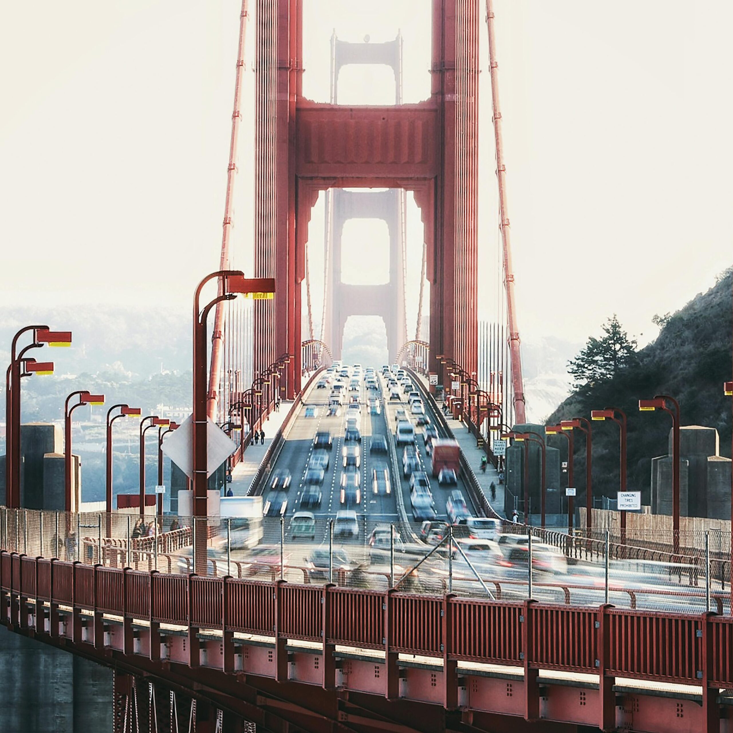 A vibrant view of traffic crossing the iconic Golden Gate Bridge in San Francisco during the day.