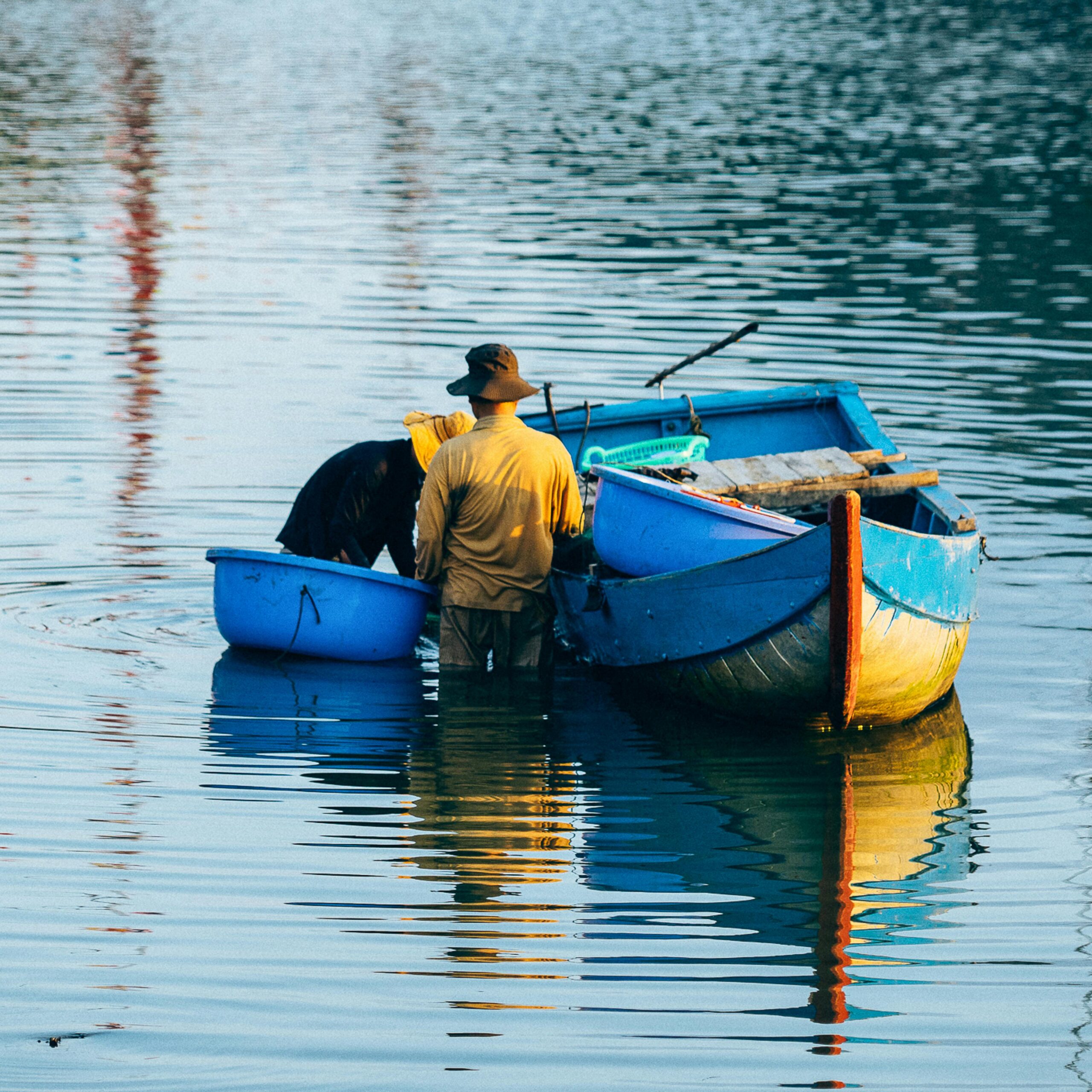 Fisherman working with a blue boat in Quy Nhơn, Vietnam waters