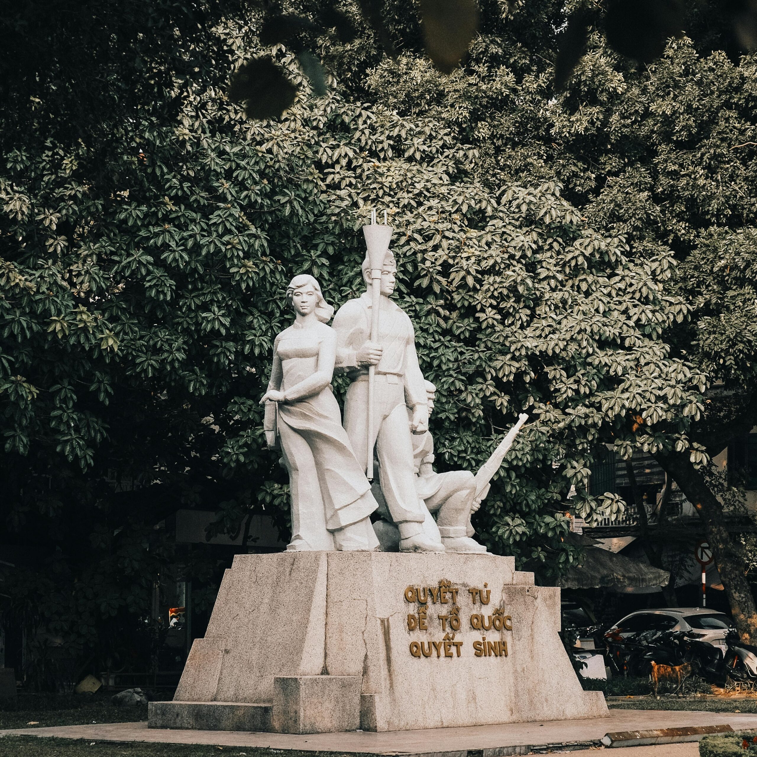 Sculpture of national significance in Hanoi, Vietnam surrounded by trees.